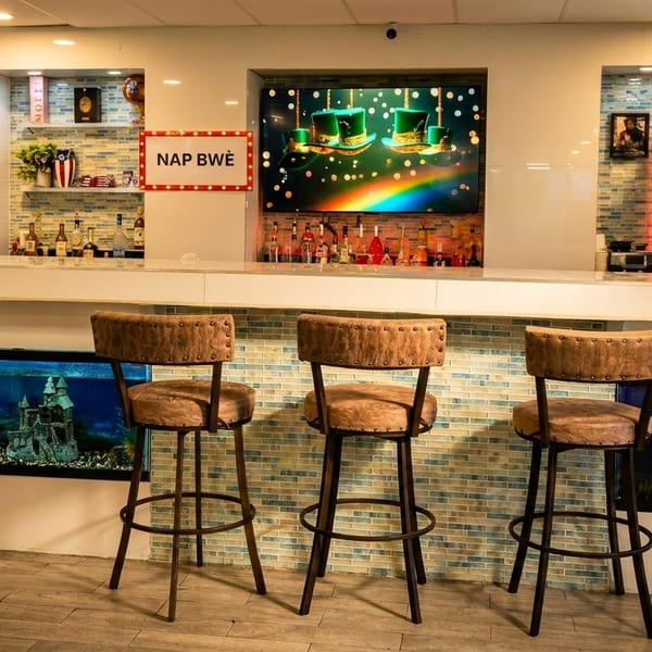 A modern bar area with three stools, an aquarium, and a screen displaying a rainbow.